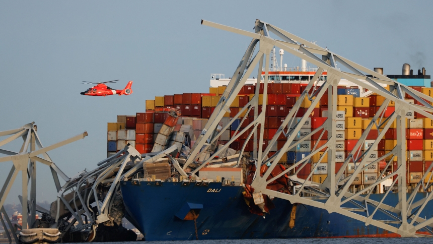 A U.S. Coast Guard helicopter hovers over the Dali cargo vessel March 26, 2024, after it crashed into the Francis Scott Key Bridge causing it to collapse in Baltimore. Within 24 hours after Baltimore Archbishop William E. Lori asked Catholics throughout the archdiocese to support twin emergency relief funds for those affected by the bridge collapse, nearly $50,000 has been raised in online donations. (OSV News photo/Julia Nikhinson, Reuters)