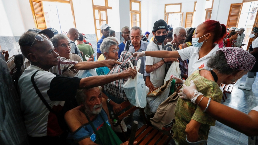 People receive containers to be filled with food for people in need at a soup kitchen in Havana that is serving a growing number of Cubans struggling to make ends meet amid economic crisis Jan. 15, 2024. Poverty is among more than a dozen issues covered by a new Vatican document on human dignity. "Dignitas Infinita" ("Infinite Dignity") was released April 8, 2024, by the Vatican's Dicastery for the Doctrine of the Faith.(OSV News photo/Yander Zamora, Reuters)