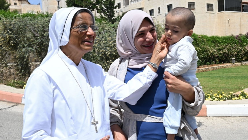 Sister Aleya Kattakayam, a member of the Sisters of Charity, greets Ayah Issa, 32, and her 18-month-old son Ahmad, outside Caritas Baby Hospital in Bethlehem, West Bank, April 27, 2024. (OSV News photo/Debbie Hill)