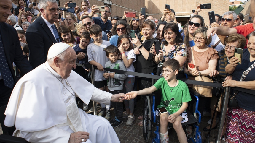 Pope Francis greets a boy outside the Rome parish of St. Bernadette Soubirous where he met with teenagers and young adults for an edition of his "School of Prayer" initiative May 24, 2024. (CNS photo/Vatican Media)