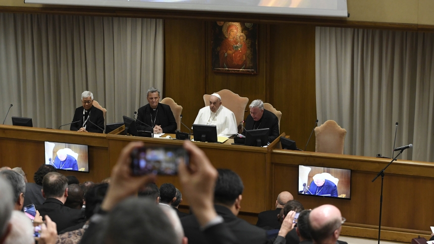 Pope Francis meets with parish priests from around the world who were chosen by their bishops to share their reflections with the Synod of Bishops on synodality May 2, 2024, in the Synod Hall at the Vatican. To the left of the pope is Cardinal Mario Grech, secretary-general of the synod, and to the right is Cardinal Jean-Claude Hollerich, synod relator general (CNS photo/Vatican Media)