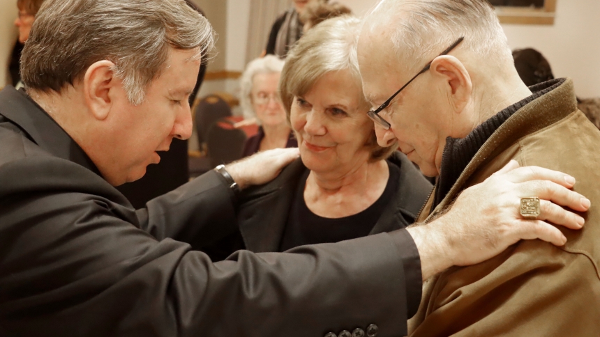 Bishop Robert J. McClory blesses Mary and Jake Neary during a visit to Sacred Heart Church in LaPorte on March 5, 2020.  (Bob Wellinski photo)