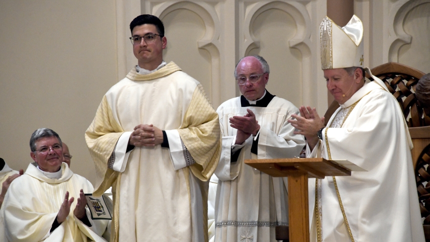 During Mass marking his 25th anniversary of priestly ordination, Bishop Robert J. McClory (right) joins other clergymen in applauding then-Deacon Zachary Glick (front, center) on the transitional deacon's final weeks before being ordained to the priesthood, on May 10 at the the Cathedral of the Holy Angels in Gary. Glick, a native of Highland and alumnus of Our Lady of Grace school, completed studies at Sacred Heart Major Seminary in Detroit. (Anthony D. Alonzo photo) 
