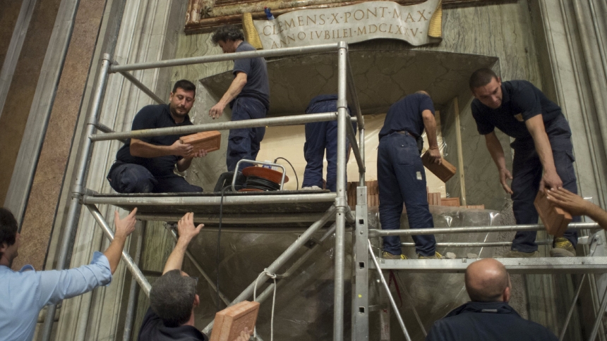 Workers remove the bricks closing up the Holy Door of St. Peter's Basilica at the Vatican in this file photo from Nov. 12, 2015. The door had been sealed shut since the end of the Holy Year 2000. (CNS photo/Vatican Media)