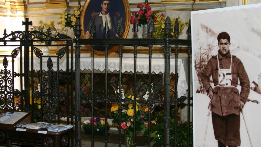 Images of Blessed Pier Giorgio Frassati appear beside and on his tomb at St. John the Baptist Cathedral in Turin, Italy, in this file photo from February 2006. (CNS file photo/Carol Glatz) 
