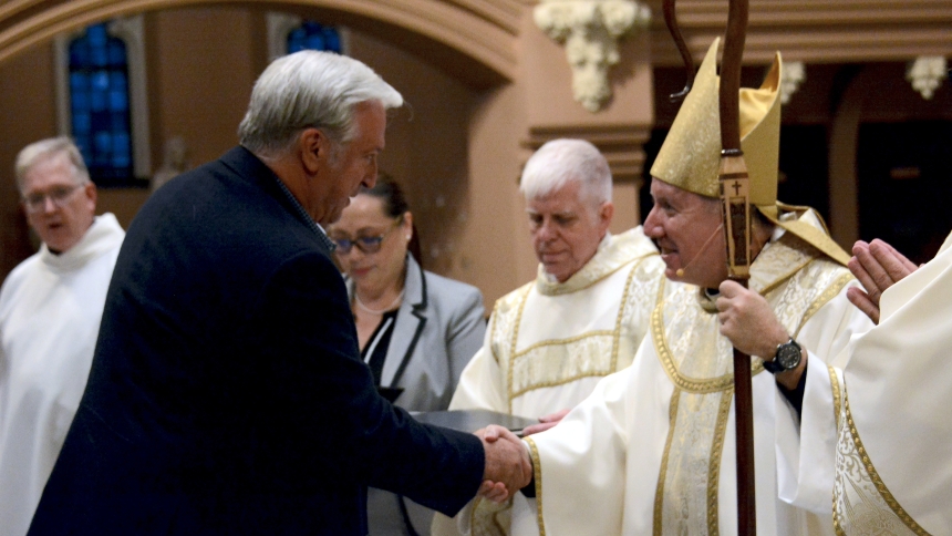 Mark Gabrione of St. Joseph parish, Dyer, shakes hands with Bishop Robert J. McClory upon receiving his diploma during the Mass with the Conferral of Certificates of Completion for graduating members of the Lay Ecclesial Ministry Program, on June 20 at the Cathedral of The Holy Angels in Gary. The LEM Class of 2024 marked the first group to utilize instruction in Spanish as well as English. (Anthony D. Alonzo photo)