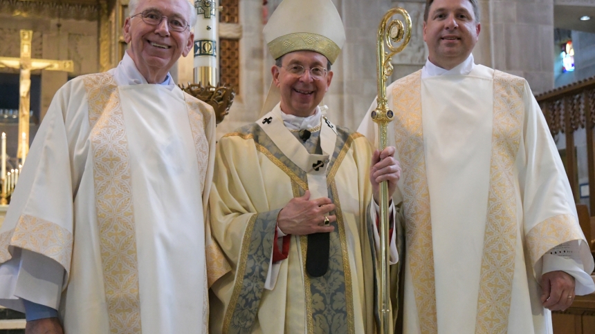 Father-and-son permanent deacons Jim and Kevin Hostutler stand with Baltimore Archbishop William E. Lori following Kevin's ordination to the diaconate at the Cathedral of Mary Our Queen May 6. (CNS photo/Kevin J. Parks, Catholic Review) See BALTIMORE-FATHER-SON-DEACONS May 9, 2017.