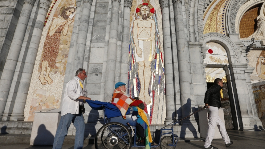 Caregivers push the sick and disabled past Father Marko Rupnik's mosaics at the Sanctuary of Our Lady of Lourdes in southwestern France in this May 16, 2014, file photo. Following accusations of spiritual, psychological or sexual abuse by multiple adult women against Father Rupnik, a Lourdes commission established in 2023 has wrapped up its consultative work and the mosaics will stay for now, the sanctuary announced July 2. But "it will eventually be necessary" to remove them, the bishop of Lourdes told the
