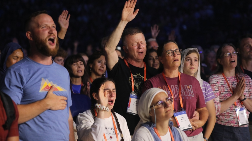 Pilgrims pray during Eucharistic adoration at the opening revival night July 17, 2024, of the National Eucharistic Congress at Lucas Oil Stadium in Indianapolis. (OSV News photo/Bob Roller)