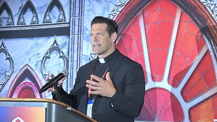 Father Mike Schmitz, director of Youth and Young Adult Ministry for the Diocese of Duluth, Minn., as well as the chaplain for the Newman Center at the University of Minnesota-Duluth, speaks to media at the National Eucharistic Congress in Indianapolis July 18. Father Schmitz is also the host of the popular Ascension podcasts "Bible in a Year" and "Catechism in a Year." (OSV News photo/Gretchen R. Crowe)