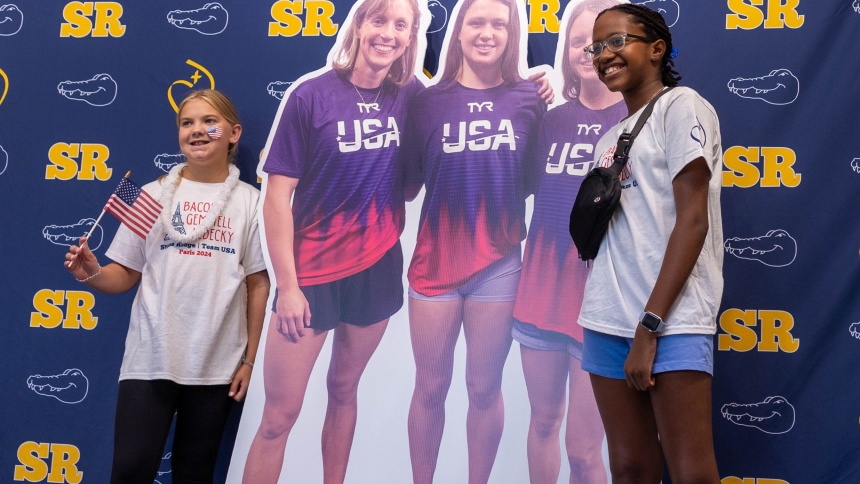 Before a July 25, 2024, pep rally at Stone Ridge School of the Sacred Heart in Bethesda, Md., students pose beside a large cutout poster of three of the school’s graduates -- Katie Ledecky (class of 2015), Phoebe Bacon (class of 2020) and Erin Gemmell (class of 2023) -- who are members of the U.S. swimming team competing in the Summer Olympics in Paris. (OSV News photo/ Mihoko Owada, Catholic Standard)