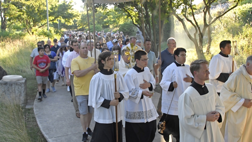 At the Shrine of Christ’s Passion in St. John, seminarians and servers lead the faithful as Bishop Robert J. McClory carries a monstrance holding the Blessed Sacrament near host St. John the Evangelist on July 4. Perpetual pilgrims on the Marian Route of the National Eucharisitc Pilgrimage visited the parish, joining local faithful for Mass, a Eucharisitc procession, praying the Rosary and a patriotic-themed drone and fireworks show. (Anthony D. Alonzo photo)