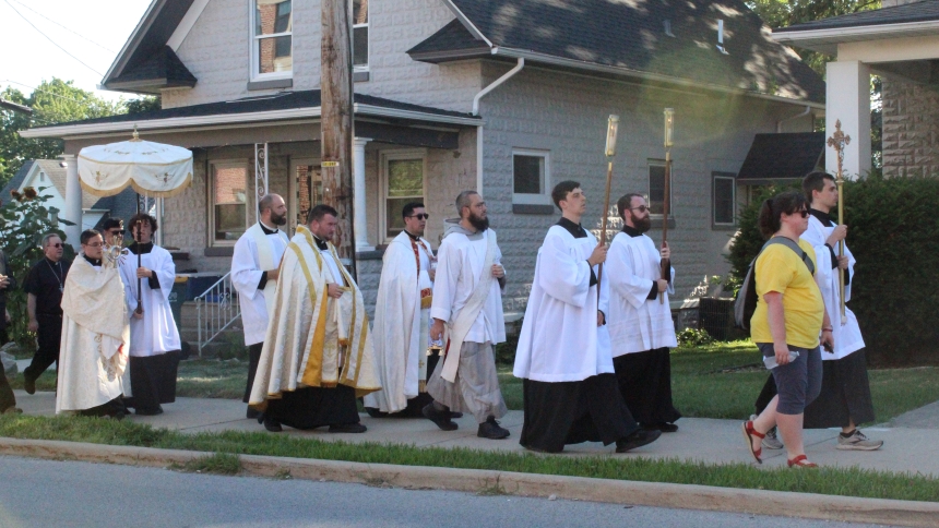 Transitional Deacon Ivan Alatorre (right) carries the Eucharist in a monstrance on the last leg of the Eucharistic Procession through Valparaiso on July 3, the third day of the five-day visit in the Diocese of Gary by the National Eucharistic Pilgrimage, headed to Indianapolis for the National Eucharistic Congress, July 17-21. (Marlene A. Zloza photo)