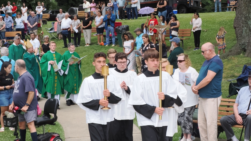 Bishop Robert J. McClory blesses the faithful during the recessional following the Holy Family Parish’s Mass in the Park at Fox Memorial Park in LaPorte on June 23. (Michael Wellinski photo) 