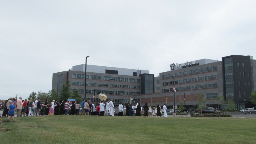 A visible display of faith is seen as a Eucharistic procession leads a group of pilgrims to Franciscan Health Michigan City along Frontage Road on July 4. (Angela Hughes photo)