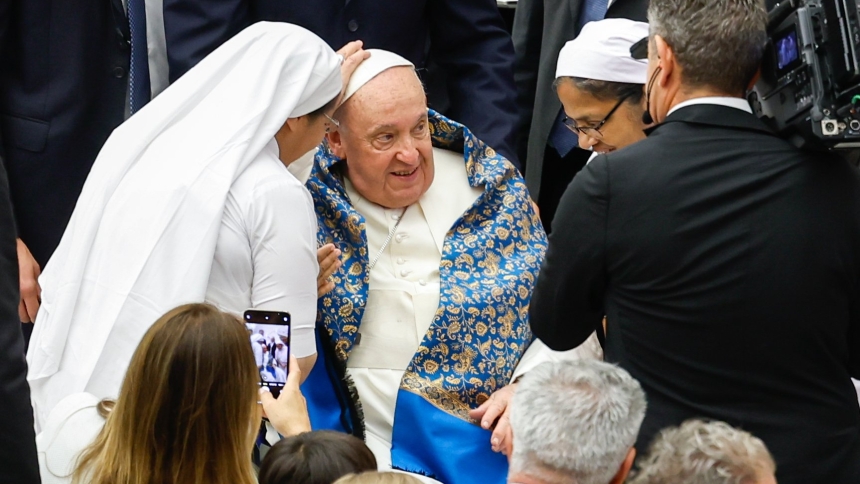 Pope Francis smiles as religious sisters greet him in the Paul VI Audience Hall at the end of his weekly general audience at the Vatican Aug. 21, 2024. (CNS photo/Lola Gomez)