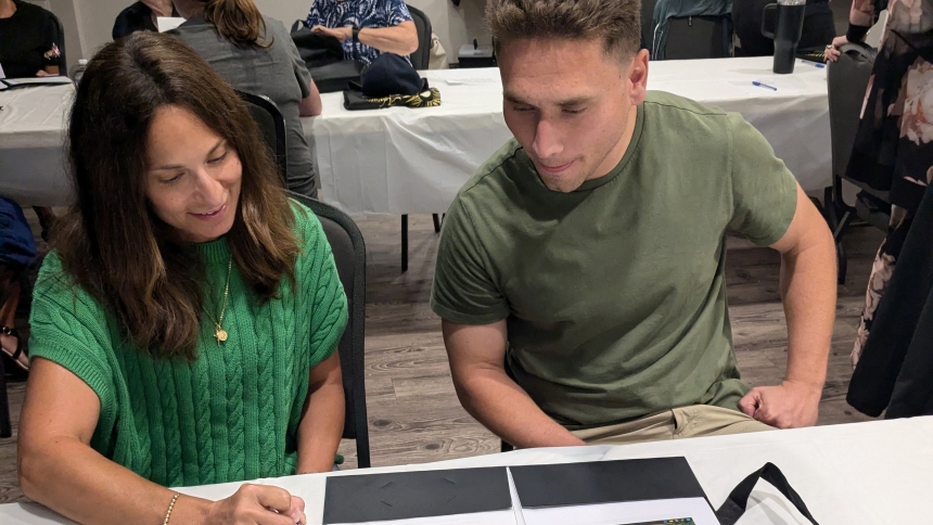 Angel Mills, who became a catechist for the first time last year at St. John the Evangelist in St. John, shares some information Aug. 5 with Nathan Puch, a new religious education classroom aide. Parishes throughout the diocese have catechists between the ages of 17 and 82 sharing their wisdom and witness to the Catholic faith. (Lynda J. Hemmerling photo)