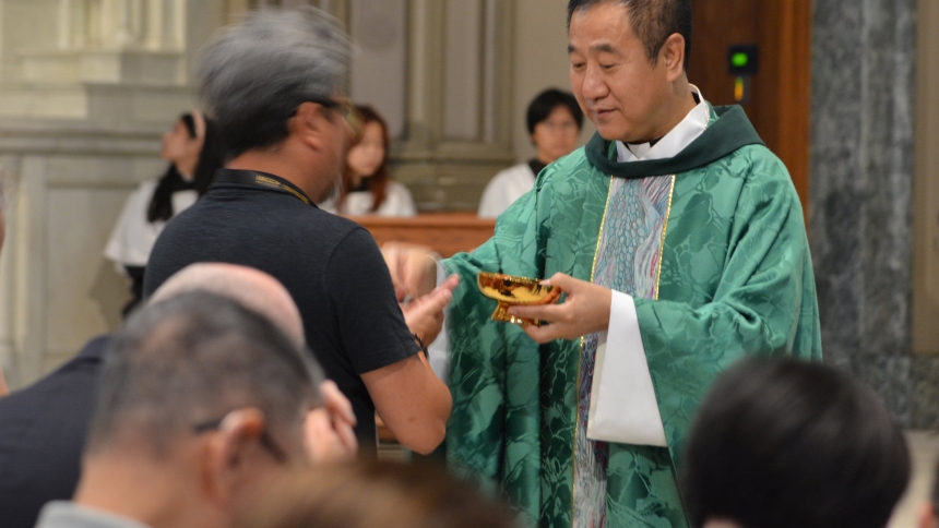 Bishop Paul Junmin Pei of Liaoning, China, distributes Communion during a Mass at St. Vincent DePaul Church -- concelebrated with Chicago Cardinal Blase J. Cupich and about 20 priests from China and the U.S. -- during a conference hosted by the US-China Catholic Church Association at Chicago's DePaul University Aug. 3, 2024. (OSV News photo/Simone Orendain)
