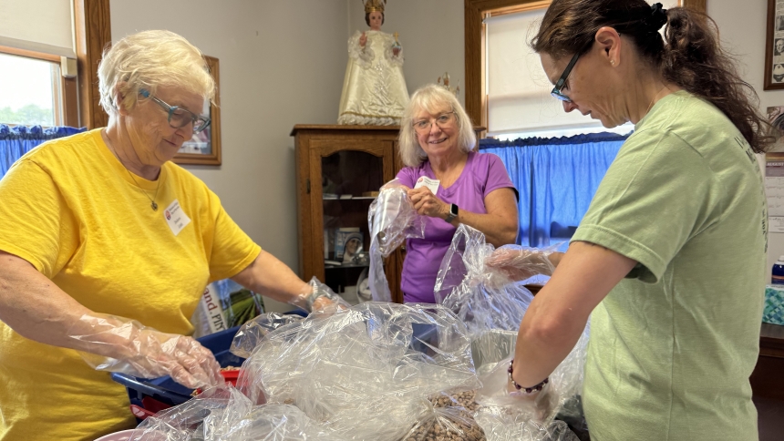 At the Missionaries of Charity convent in Gary (left to right) Dolores Little, Elizabeth Ring and Lynda Klekowski pack pinto beans for distribution to food pantries during the diocesan Day of Service on Aug. 17.  Dozens of area faithful assisted in charitable endeavors putting faith into action as part of the National Eucharistic Revival implementation. (Anthony D. Alonzo photo)