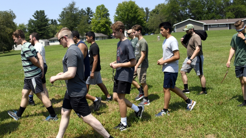 Seminarians and discerners pray the Rosary while enjoying a hike during the Quo Vadis retreat at Camp Lawrence in Porter County on Aug. 5. The three-day sessions named after the Latin phrase meaning "Where are you going?" afforded the opportunity for young men considering a priestly vocation to interact with diocesan seminarians in prayer, catechesis and recreational activities. (Anthony D. Alonzo photo)