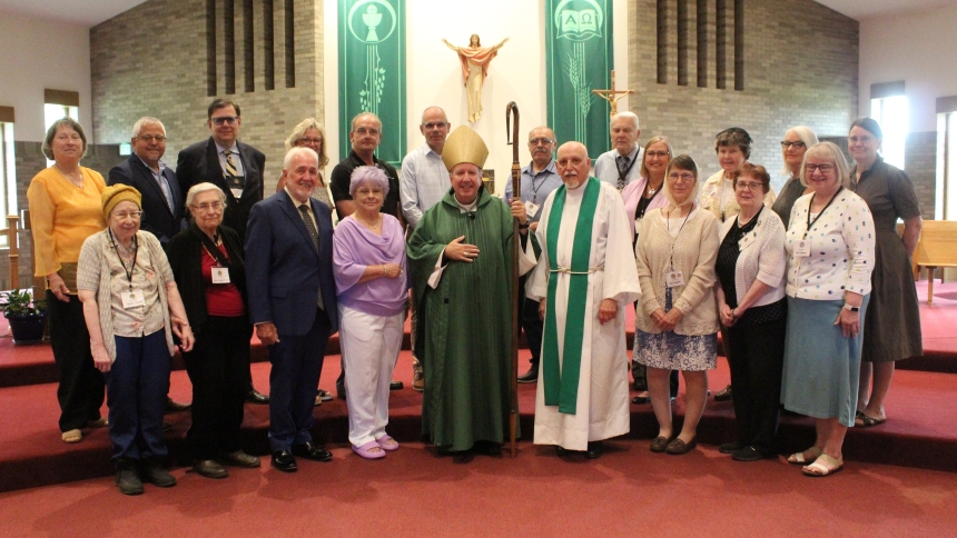 Members of the Serra Club of Northwest Indiana gather with Diocese of Gary Bishop Robert J. McClory (front row center) and club chaplain Father Dominic Bertino (to the bishop's left) to celebrate the club's 70-year anniversary with a Mass and luncheon on July 28. (Marlene A. Zloza photo)