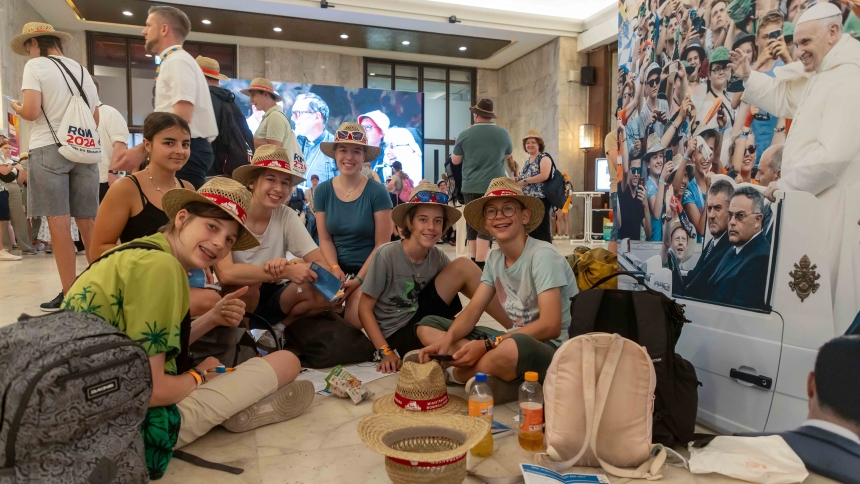 A group of young people pose for a photo at a temporary pilgrimage center in a Rome auditorium during the XIII International Pilgrimage of Altar Servers in Rome July 31, 2024.  More than 50,000 altar servers from 20 countries went to Rome for the July 29-Aug. 2 pilgrimage. (CNS photo/Pablo Esparza)