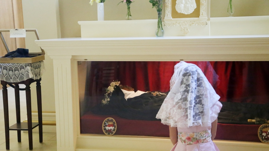 A young girl kneels before the St. Joseph shrine where the body of Sister Mary Wilhelmina Lancaster, foundress of the Benedictines of Mary, Queen of Apostles, lies in the Abbey of Our Lady of Ephesus in Gower, Mo., May 26, 2024. (OSV News photo/Megan Marley)