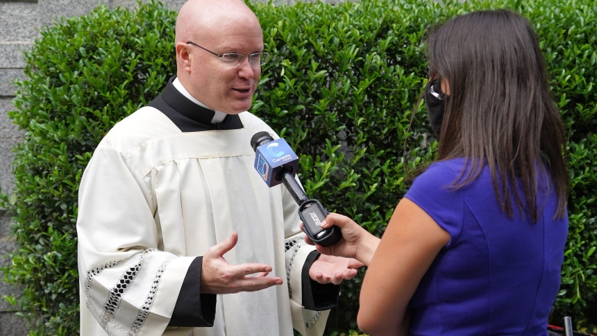 Father Roger Landry speaks with reporter Emily Drooby of NET TV, of the Diocese of Brooklyn, N.Y., prior to a prayer service for U.N. diplomats Sept. 14, 2020, at Holy Family Church in New York City. The Pontifical Mission Societies USA announced Sept. 5, 2024, that Father Landry has been named its new national director, effective in January. (OSV News photo/Gregory A. Shemitz, CNS Archive)