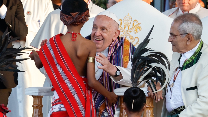 Pope Francis greets a child in traditional dress during a welcome ceremony at the presidential palace in Dili, Timor-Leste, Sept. 9, 2024. (CNS photo/Lola Gomez)