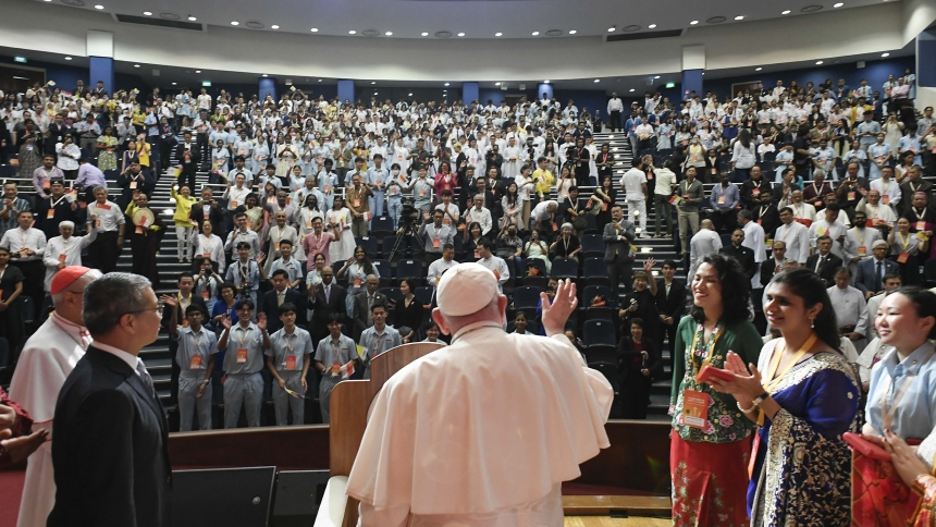 Pope Francis waves to young people gathered for a meeting on interreligious dialogue at the Catholic Junior College in Singapore Sept. 13, 2024. (CNS photo/Vatican Media)