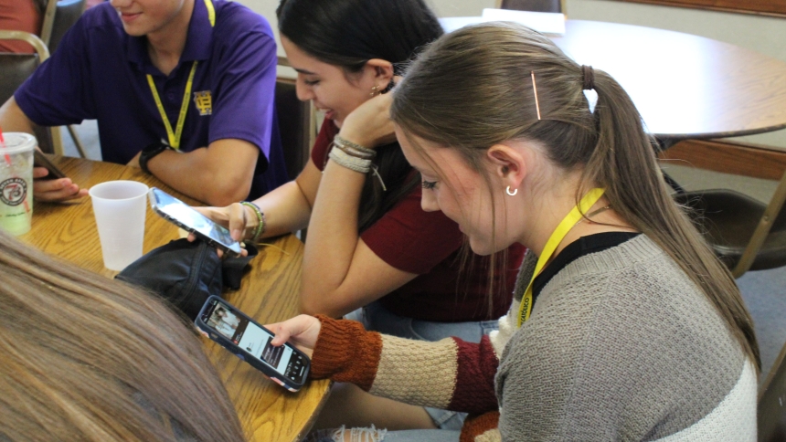High school students Richard Rappold of Conway, Ark., Yajaira Trenado of Searcy and Ashley Wagner of Jacksonville look at their phones during breakfast before a Youth Advisory Council meeting at St. John Center in Little Rock Aug. 18, 2024. (OSV News photo/Katie Zakrzewski, Arkansas Catholic)