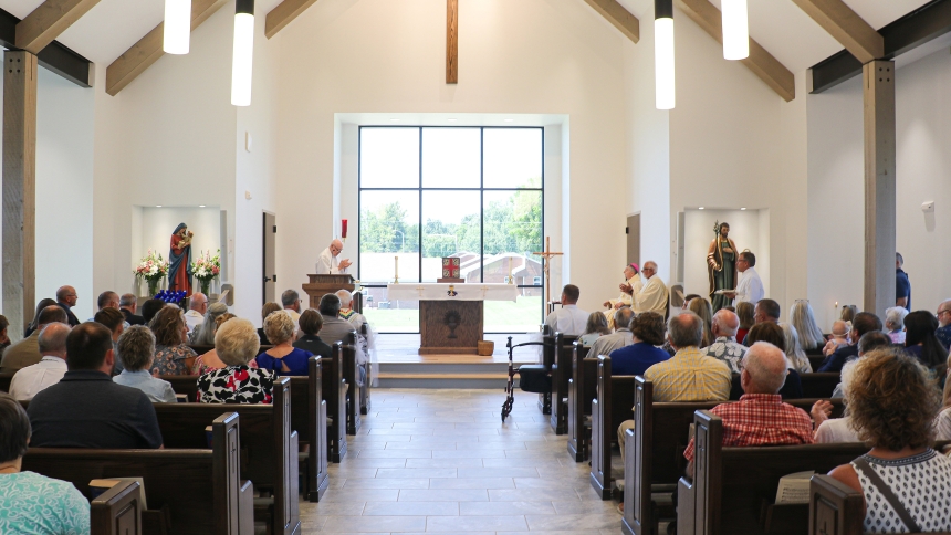 Father David Kennedy, pastor of Resurrection Parish in Dawson Springs, Ky., leads the full church in applauding Decon Mike Marsili for his leadership amid the church's recovery and rebuilding, during the dedication Mass Aug. 17, 2024. The original church building was destroyed by a historic tornado on Dec. 10, 2021. (OSV News photo/Riley Greif, The Western Kentucky Catholic)