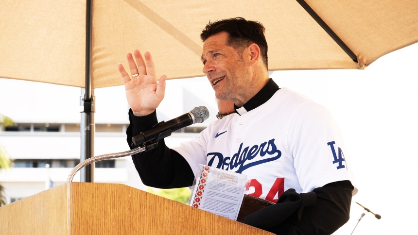 Popular podcast host and university chaplain Father Mike Schmitz speaks to a sold-out crowd of more than 2,000 at the Los Angeles Catholic Prayer Breakfast Sept. 17, 2024. He's wearing a Dodgers jersey given to him by the event's organizers with the No. 24 on it with his name on the back. Organizers also gave him a Dodgers cap with Archbishop Gomez's autograph. (OSV News photo/Victor Aleman, Angelus News)