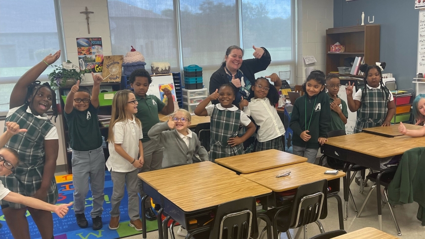 New principal Maegan Veleeparambil (center) and second graders at Aquinas Community School in Merrillville show by their thumbs up sign that they are ready for a successful 2024-25 school year. (Provided photo)