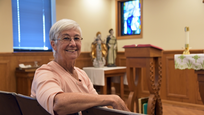 Cathy Bartczak is seated before the altar in the Holy Spirit chapel at the Pastoral Center in Merrillville on Sept. 3. The St. Michael the Archangel parishioner is an active senior and volunteer in several church ministries, including one which had a positive impact on her returning to regular Mass attendance: the hospitality group. (Anthony D. Alonzo photo) 
