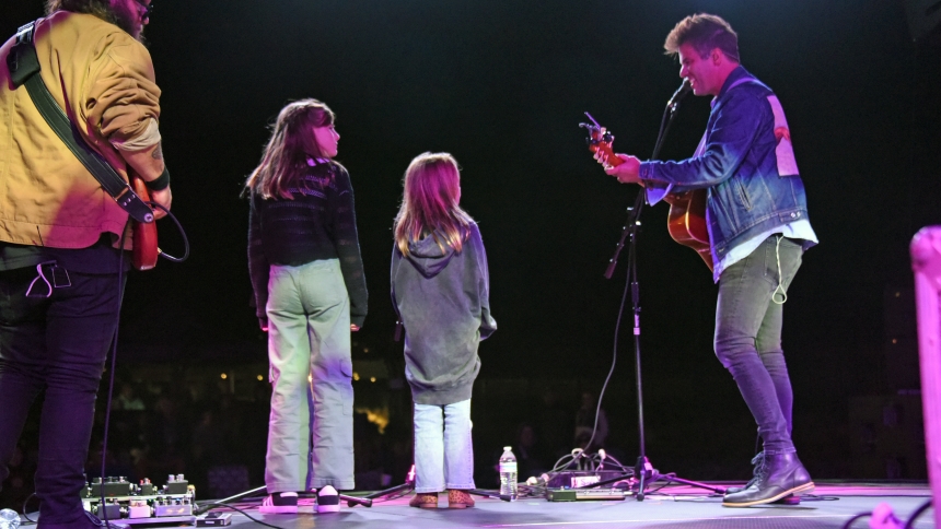PJ Anderson (right), a Nashville recording artist, sings self-penned praise and worship songs with his daughters Elliot (middle), 8, and Claire (second from left), 11, on Sept. 7 during the Let Your Light Shine concert event at Our Lady of Guadalupe Plaza in St. John. The Catholic crooner returned to play at his hometown St. John the Evangelist Church during Mass for the first time since 2010; he had not performed at The Shrine of Christ's Passion since 2019. (Anthony D. Alonzo photo)