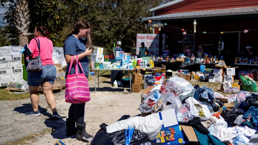 Maddie Hackney, who lost everything to the hurricane, pauses while looking for clothing Sept. 29, 2024, at a donation center in Steinhatchee, Fla.,  organized by Janalea and Garrett England at their business Steinhatchee Fish Co. in the wake of Hurricane Helene. (OSV News photo/Kathleen Flynn, Reuters)     