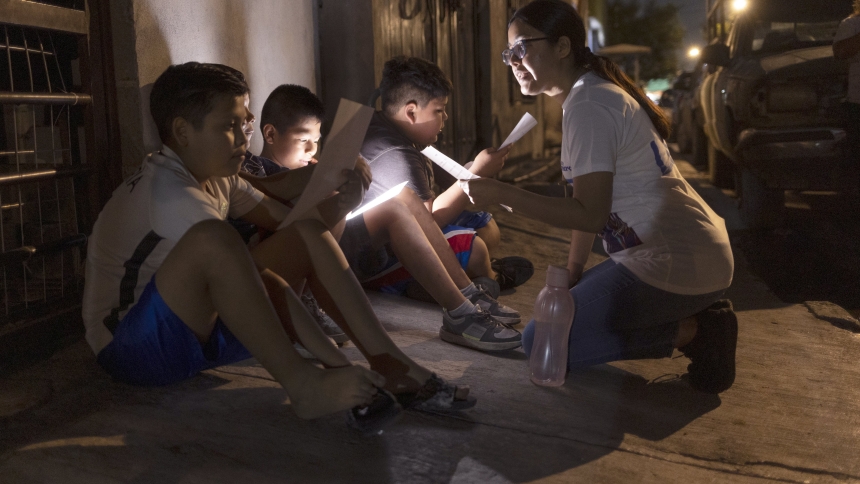 Lay missionary Josseline Montes Jiménez, right, teaches religious acclamations to members of Los Monckis, a street gang, during a May 18, 2023, visit to their hangout in Monterrey, Mexico. The Catholic Church’s annual World Mission Sunday observance, which is Oct. 20, 2024, is a day to renew the church's commitment to missionary work and to show solidarity with those who share the faith overseas. (OSV News photo/Nuri Vallbona, Global Sisters Report)