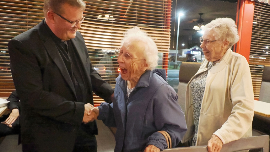 Father David Kime shares a laugh with Queen of All Saints parishioners Catherine Garrabrant and Kathy Brill following his Tapped In talk on Oct. 9 at Gelsosomo’s Pizzeria in Michigan City. The seasoned priest said as much as he nourishes the spirituality of his parishioners, he feels fed by their support and love. (Deacon Bob Wellinski photo)