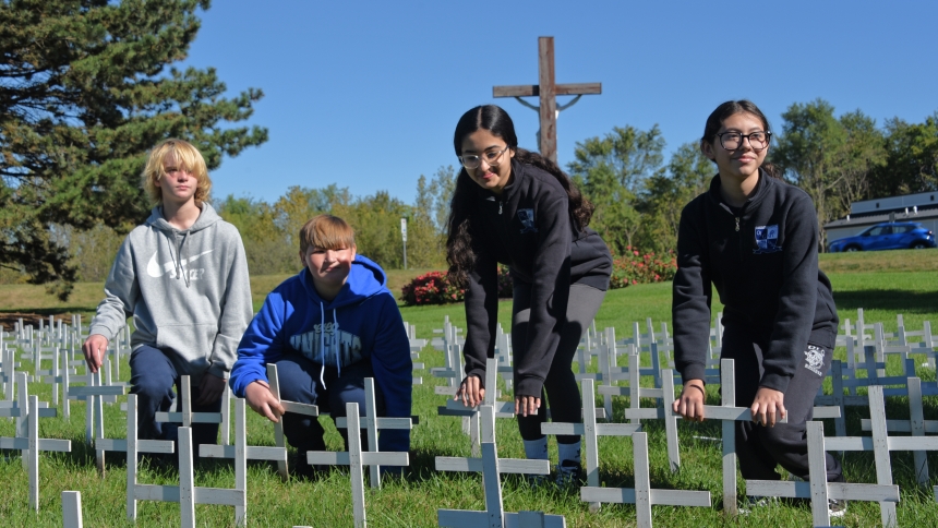 Among hundreds of students gathered at Franciscan Health Dyer, Our Lady of Grace eighth-graders (left to right) Carter Wedryk, Matthew Ball, Carolina Ruiz and Jimena Nazario each plant a cross in the ground to represent an unborn child lost to abortion, as part of the Respect Life Prayer Service on Oct. 2. According to hospital officials, the annual event aims to "celebrate all life with an emphasis on individual life and to draw attention to the lives lost to abortion." (Anthony D. Alonzo photo)