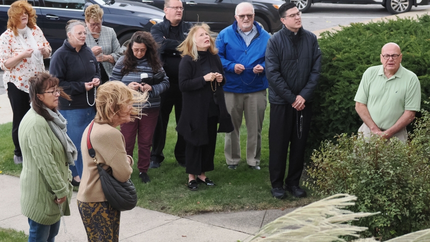 Strong winds and sprinkles didn’t deter a group of faithful from processing in the neighborhood near St. Mary the Immaculate Conception concluding by praying the rosary outside the church. (Deacon Bob Wellinski photo)