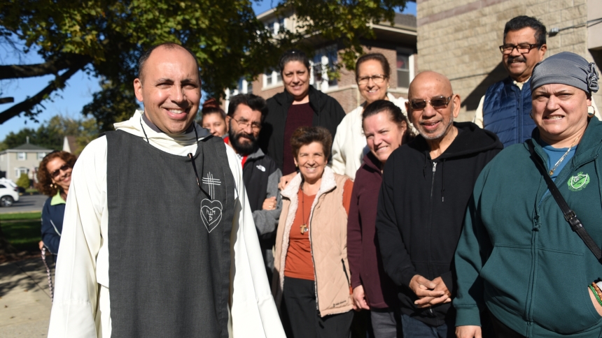 Association of the Immaculate Conception Father Julio Bedoya gathers with parishioners after a morning Mass on Oct. 8 at St. Mary church in East Chicago, where he is pastor. Father Bedoya, a native of Columbia, came to a deeper faith as a discerner among a religious order and finds great joy in serving parishioners who he said show much gratitude. (Anthony D. Alonzo photo)