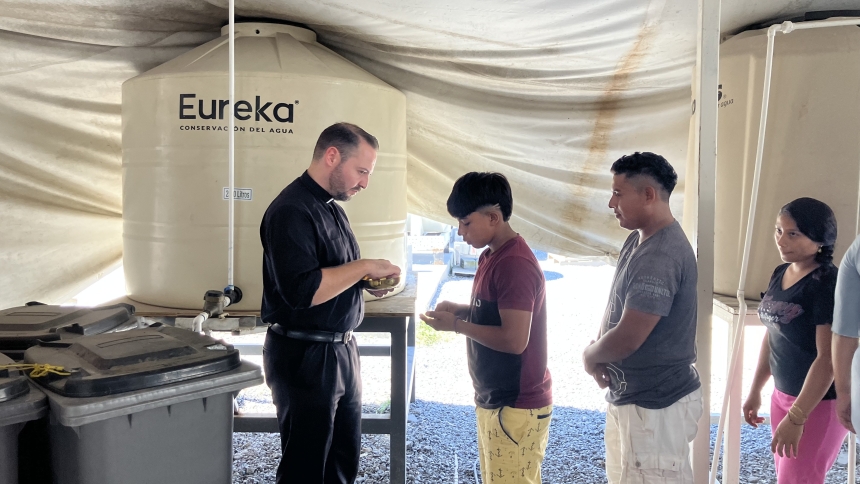 Jesuit scholastic Joseph Nolla distributes Communion during Mass celebrated Oct. 15, 2024, at the Senda de Vida migrant shelter in Reynosa, Mexico. (OSV News photo/David Agren)