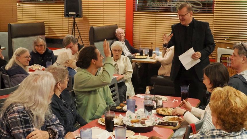 Father David Kime, pastor of Queen of All Saints and St. Mary the Immaculate Conception, takes questions following his talk on religious order during QAS’s Tapped In evening at Gelsosomo’s Pizzeria on Oct. 9. (Deacon Bob Wellinski photo)