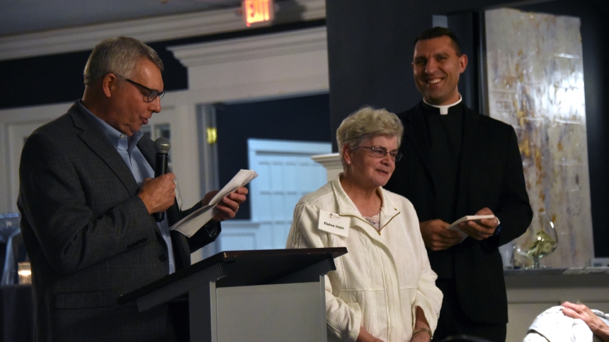 Gary Bonk (left), vice president of the Catholic Foundation for Northwest Indiana, introduces Elaine Hein (center) of St. Mary, Crown Point, as Father Christopher Stanish (right), vicar general and moderator of the curia, watches at the annual Mercy Fund grants award dinner on Nov. 6 at Innsbrook Country Club in Merrillville. Managing $18.5 million in endowed assets, the non-profit, independent organization provides an avenue for faithful to invest in the future of acamedic, charitable and faith-related cau
