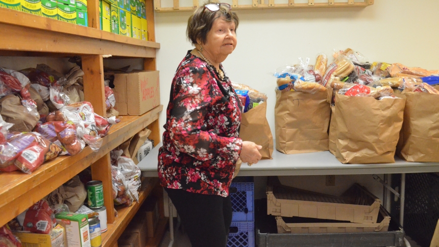 Food pantry volunteer Ruthie Polito helps gather grocery items for clients at the Catholic Charities location in East Chicago during operation hours on the morning of Nov. 8. The pantry has already begun adding special food items to distribution ahead of the Thanksgiving holiday. (Erin Ciszczon photo)