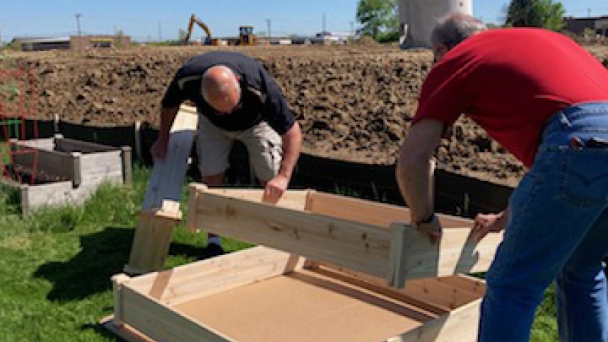 Members of St. Vincent de Paul assist with setting up raised garden beds at Holy Spirit in Winfield. The garden was started in 2021 thanks to a generous donation and the support of the parish community. (Provided photo)