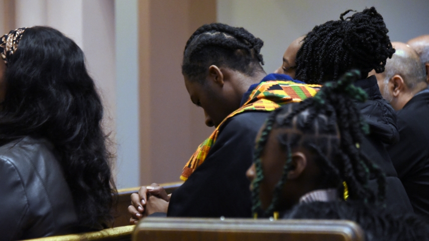 Members of the Tameka Freeman (top) family pray during Mass, which preceded a fellowship gathering on Nov. 17 at the Cathedral of the Holy Angels in Gary. The event called to mind the designation by the Church of Black History Month, when since 1990, U.S. faithful have joined together in worship, education, charity and entertainment to recognize heritage of Africa and the African Diaspora in the Catholic Church. (Anthony D. Alonzo photo)