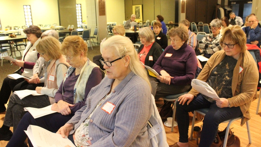 Following along in the manual prepared by presenter Sheri Wohlfert, read aloud how to turn hospitality into evangelization as during a parish mission on Nov. 8-9 at St. Helen in Hebron. Wohlfert set out to prepare her audience "for receiving others in the name of Jesus Christ in your parishes and homes while also equipping participants with the skills to share the Gospel with confidence and joy." (Marlene A. Zloza photo)