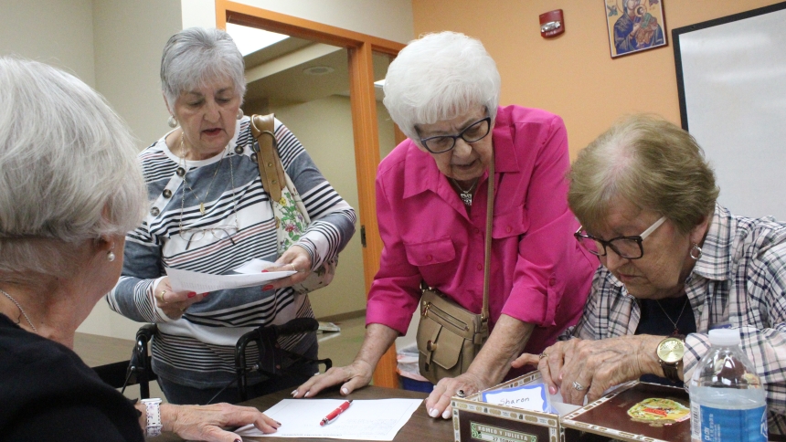Pat Mroczkowski (right) checks the registration files as members (from left, with back to camera) Trudy Tarpo, Linda Miller and Betty Shahbaz sign in at the Sept. 26 meeting of the Catholic Widows and Widowers group at St. Matthias in Crown Point. The group hosts a social meeting, usually offsite, on the secon Thursday every month, and a business meeting with a snacks and a guest speaker, at 1 p.m. on the fourth Thursday. (Marlene A. Zloza photo)